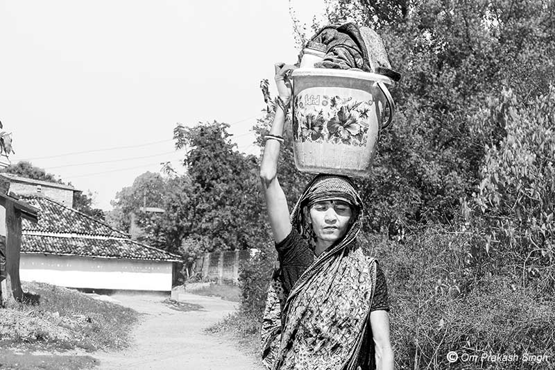 Heading towards the village pond to wash clothes and bathe in Seraikela-Kharsawan district, Jharkhand, India